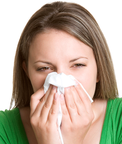 Woman sneezing into a tissue